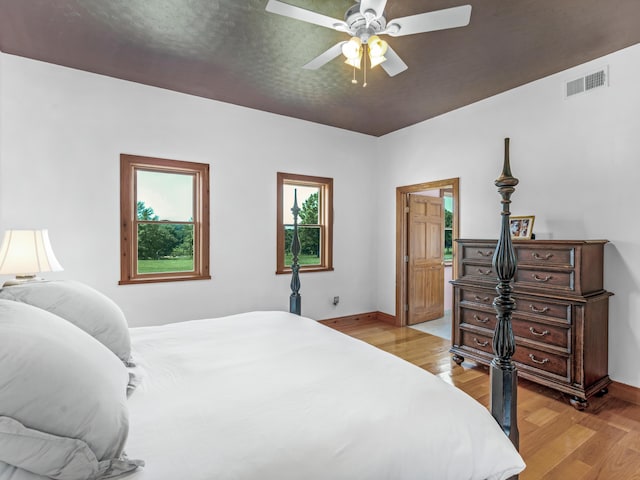 bedroom with light hardwood / wood-style floors and ceiling fan