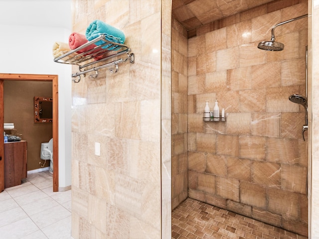 bathroom with a tile shower and tile patterned flooring