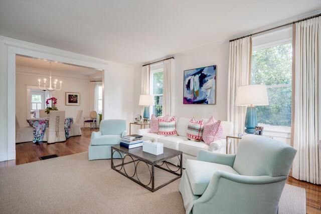 2619 Raymond Ave, Augusta, GA 30904 - living area featuring an inviting chandelier, crown molding, wood finished floors, and visible vents