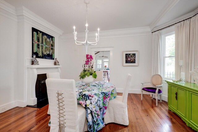 2619 Raymond Ave, Augusta, GA 30904 - dining space with crown molding, a chandelier, plenty of natural light, and hardwood / wood-style floors