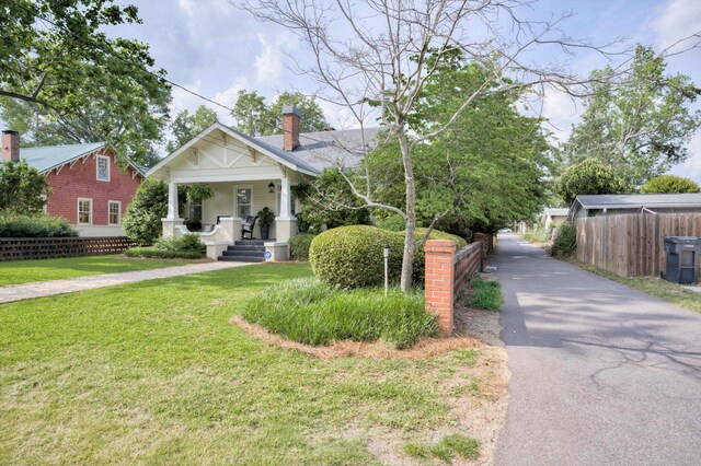 2619 Raymond Ave, Augusta, GA 30904 - view of front of house featuring a porch, driveway, a chimney, a front yard, and fence