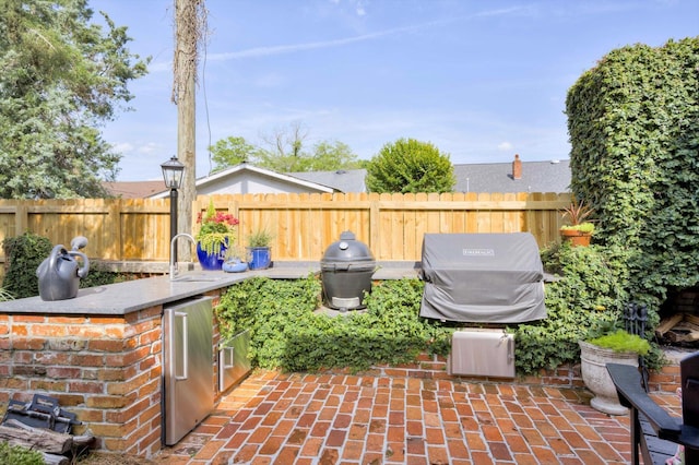 2619 Raymond Ave, Augusta, GA 30904 - view of patio / terrace with a sink, an outdoor kitchen, fence, and area for grilling