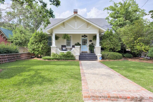 2619 Raymond Ave, Augusta, GA 30904 - bungalow-style house with fence, a chimney, a porch, and a front lawn