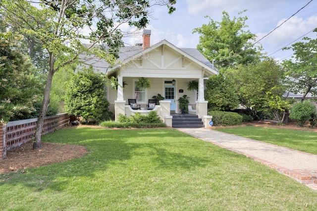 2619 Raymond Ave, Augusta, GA 30904 - bungalow-style house with covered porch, fence, a chimney, and a front yard