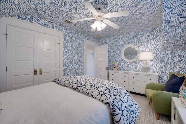 2619 Raymond Ave, Augusta, GA 30904 - bedroom featuring wallpapered walls, light carpet, ceiling fan, and a closet