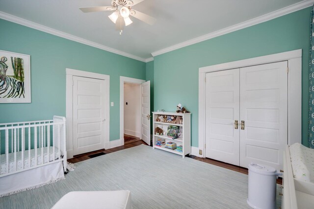 2619 Raymond Ave, Augusta, GA 30904 - bedroom with a closet, ornamental molding, wood finished floors, ceiling fan, and a nursery area