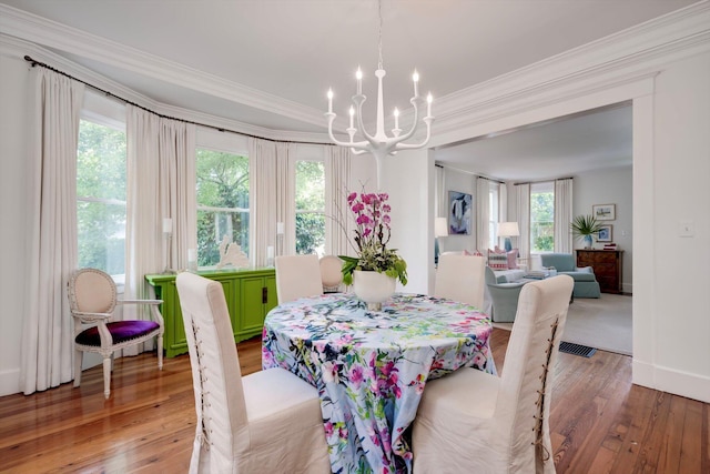 2619 Raymond Ave, Augusta, GA 30904 - dining space featuring crown molding, a notable chandelier, hardwood / wood-style floors, baseboards, and visible vents