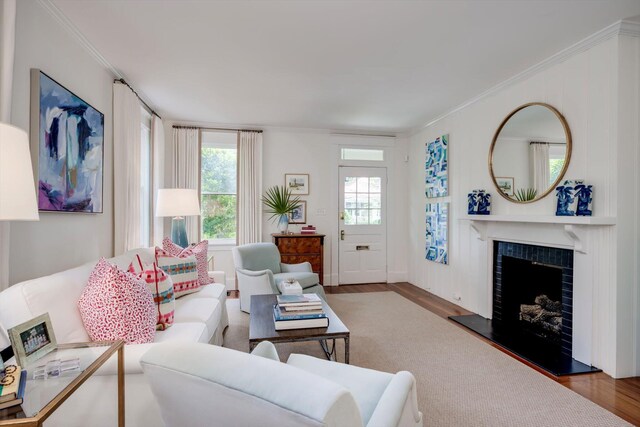 2619 Raymond Ave, Augusta, GA 30904 - living room with crown molding, a wealth of natural light, wood finished floors, and a tile fireplace