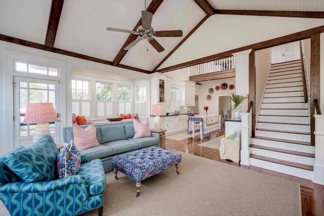 2619 Raymond Ave, Augusta, GA 30904 - living area featuring a ceiling fan, stairway, high vaulted ceiling, beamed ceiling, and light wood-style floors