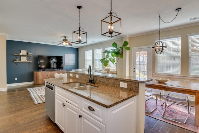 kitchen with sink, white cabinetry, hanging light fixtures, dishwasher, and a kitchen island with sink