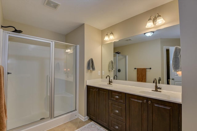 bathroom with tile patterned floors, a shower with shower door, and vanity