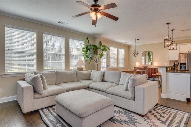 living room with crown molding, ceiling fan, and dark hardwood / wood-style flooring