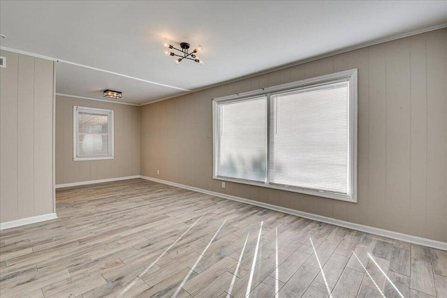 empty room with light hardwood / wood-style flooring