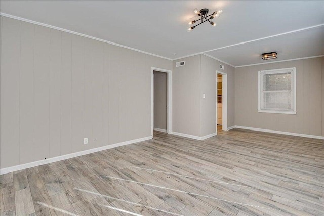 unfurnished room with crown molding and light hardwood / wood-style floors