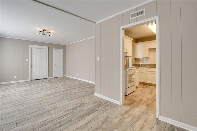 unfurnished living room with crown molding, light hardwood / wood-style flooring, and wooden walls