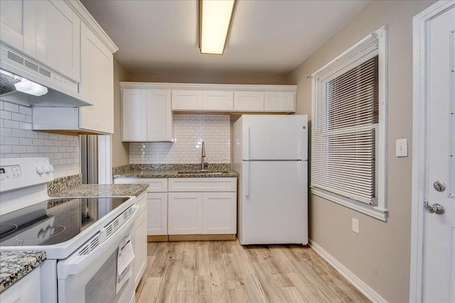 kitchen with sink, backsplash, white cabinets, and white appliances