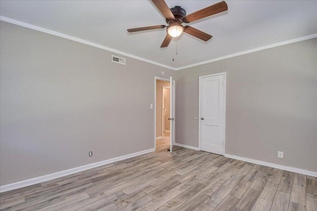 empty room featuring ceiling fan, ornamental molding, and light hardwood / wood-style flooring