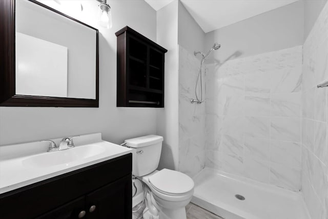 full bathroom with vanity, toilet, and a stall shower
