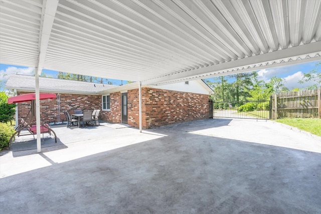 view of patio / terrace with fence, outdoor dining area, and a gate