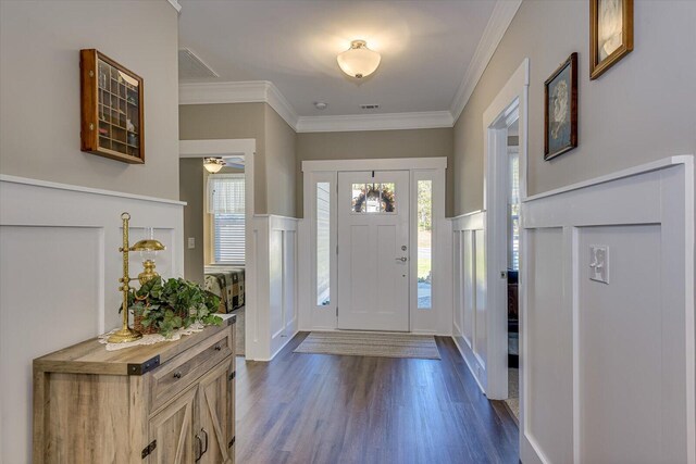 foyer entrance featuring dark hardwood / wood-style flooring, ceiling fan, and crown molding