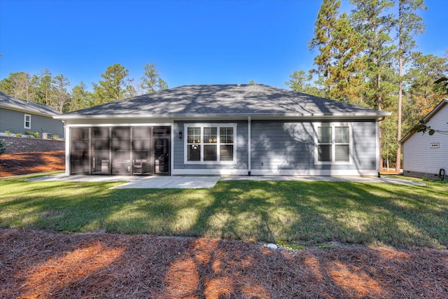 rear view of house featuring a yard