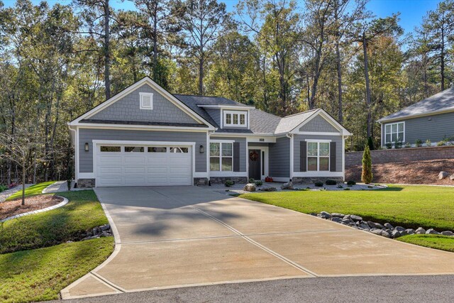 craftsman-style home with a front yard and a garage