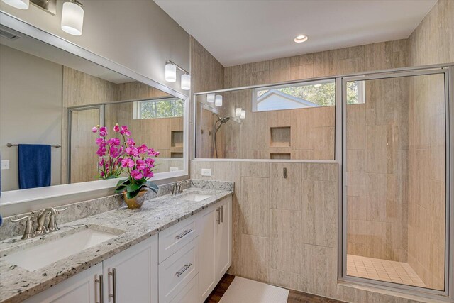 bathroom featuring vanity and a shower with shower door