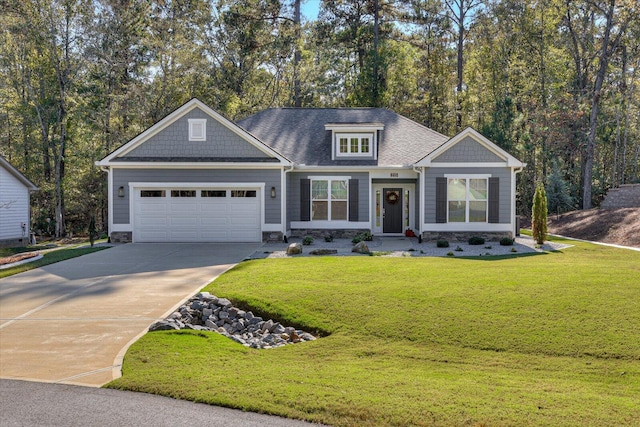 craftsman house with a front yard and a garage