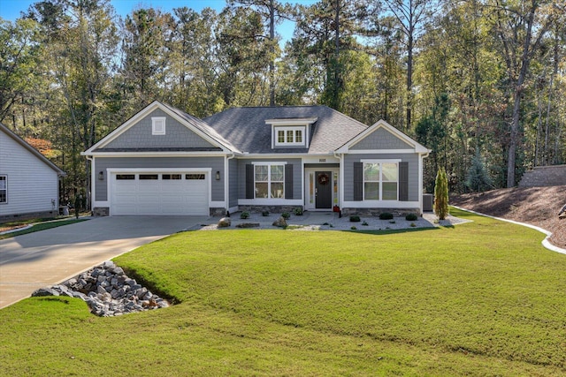 craftsman house featuring a front yard and a garage