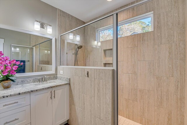 bathroom with vanity and a shower with shower door