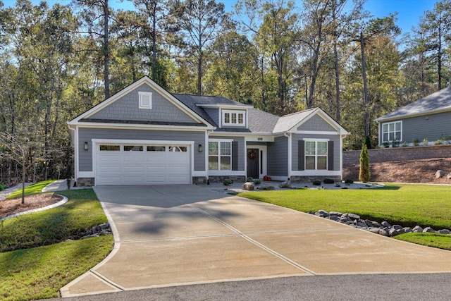 craftsman-style house with a garage and a front lawn