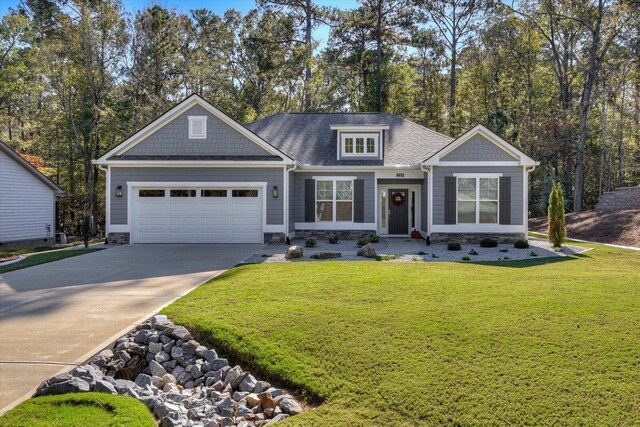 craftsman house featuring a garage and a front lawn