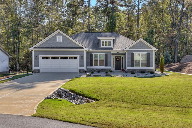 craftsman-style home featuring a garage and a front lawn