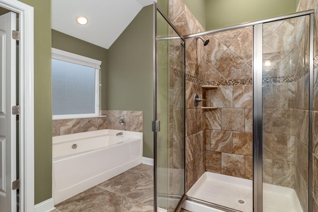 bathroom with separate shower and tub and vaulted ceiling