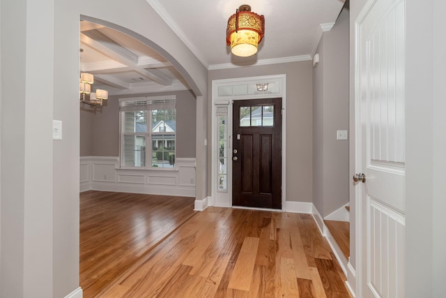 foyer entrance with beamed ceiling, hardwood / wood-style flooring, crown molding, and coffered ceiling