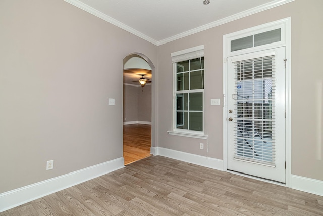 spare room featuring ceiling fan, ornamental molding, and light hardwood / wood-style flooring