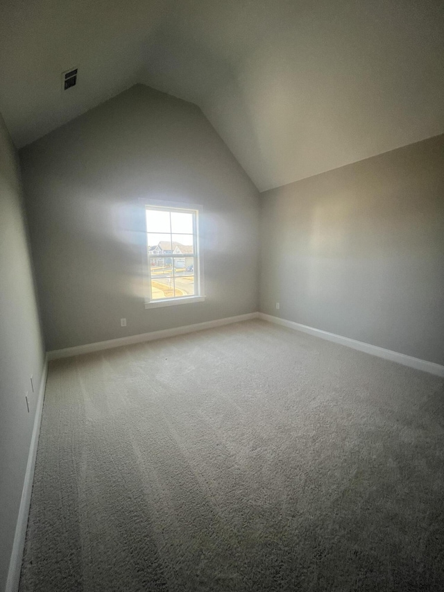 bonus room featuring vaulted ceiling, carpet flooring, and baseboards