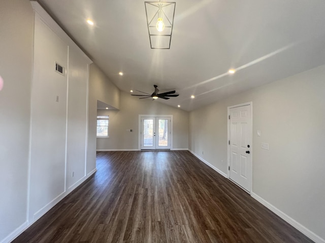 empty room featuring lofted ceiling, dark hardwood / wood-style floors, french doors, and ceiling fan