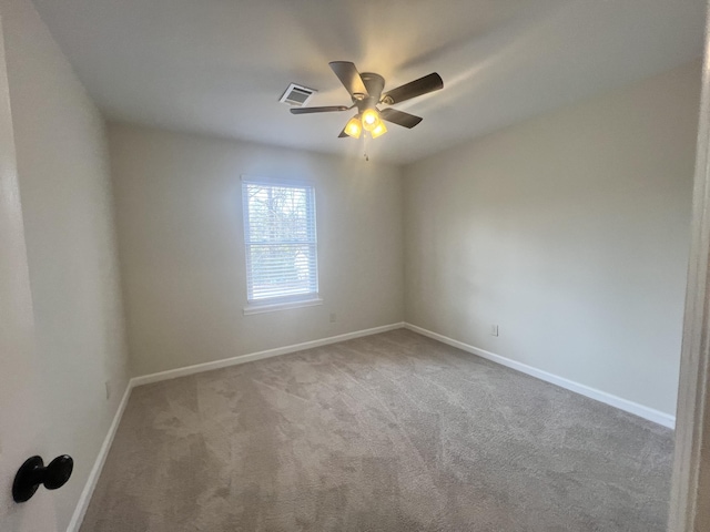 carpeted spare room with ceiling fan