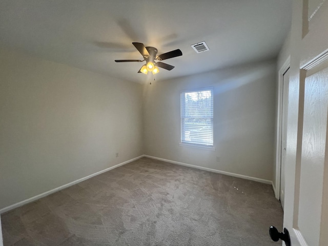 spare room featuring ceiling fan and carpet