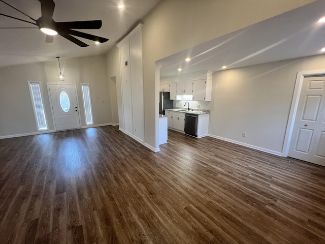 unfurnished living room featuring lofted ceiling, sink, and dark hardwood / wood-style floors