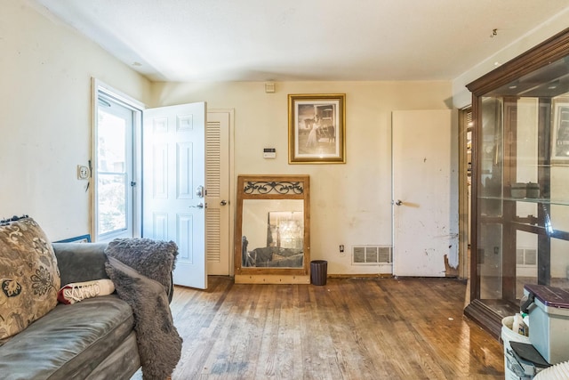 living area with wood finished floors and visible vents