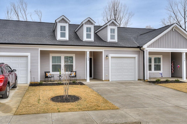 view of front of property featuring driveway, a shingled roof, a garage, and board and batten siding