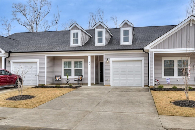 view of front of house with a garage, driveway, and a shingled roof