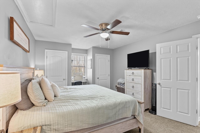 carpeted bedroom with a textured ceiling and ceiling fan