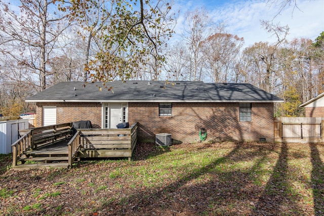 back of house with a yard, central AC, and a deck