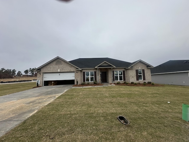 ranch-style house featuring a garage and a front lawn