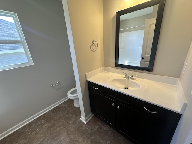 bathroom with vanity, walk in shower, and toilet