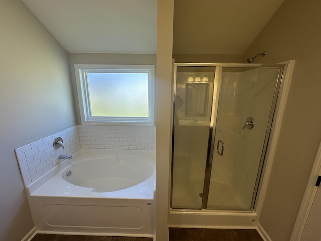 bathroom with shower with separate bathtub and lofted ceiling