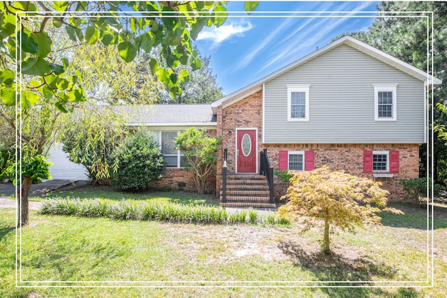 tri-level home with a front yard and a garage